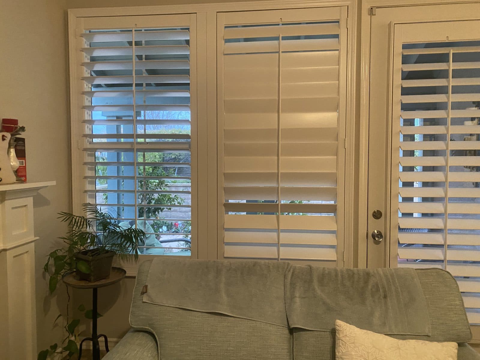 White plantation shutters fitted around a bay window. Real AAA Shutter Repair job photo.
