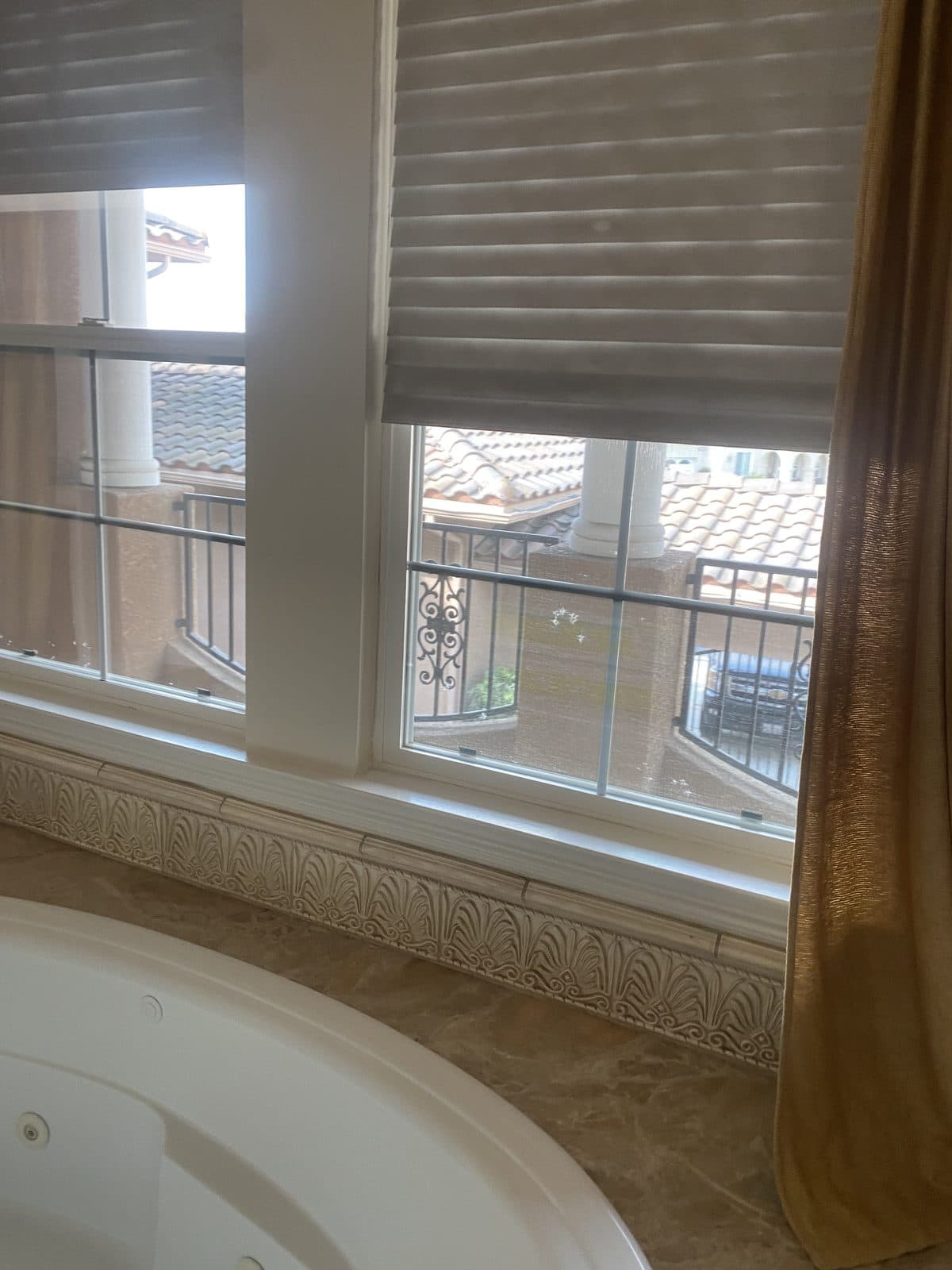Faux wood blind with the valance lifted to show the headrail brackets