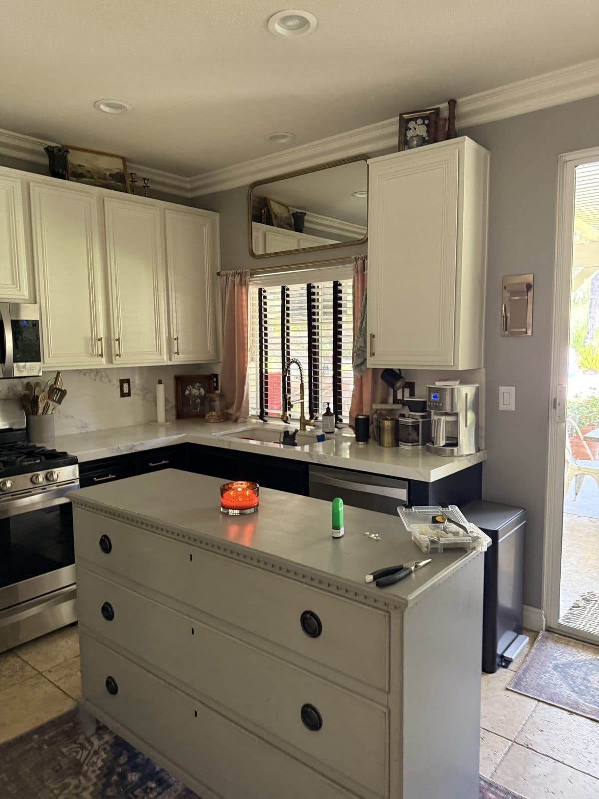 White plantation shutters beside a brass lamp in a bedroom. Real AAA Shutter Repair job photo.