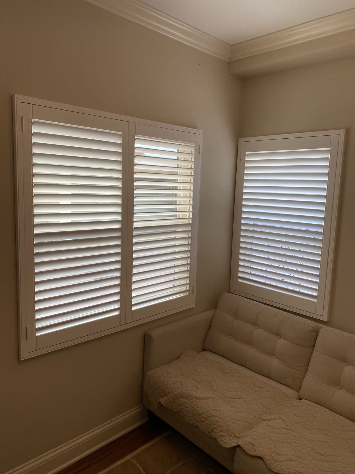 Wood blind with the valance lifted and a tilt wand hanging down. Real AAA Shutter Repair job photo.